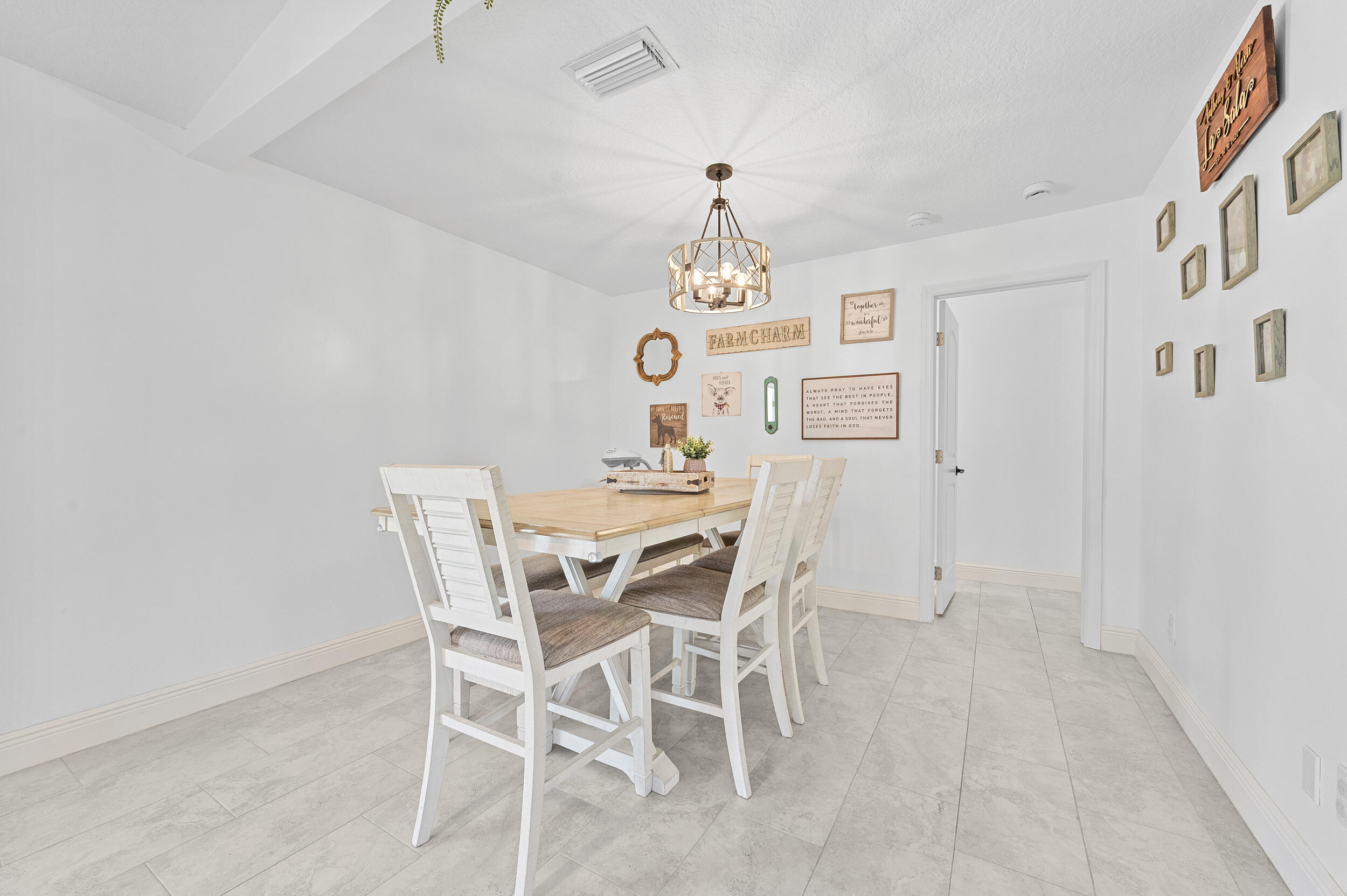 18389 41st Road North The Acreage, FL 33470 - Photo 18 of 44 a view of a dining room with furniture and chandelier