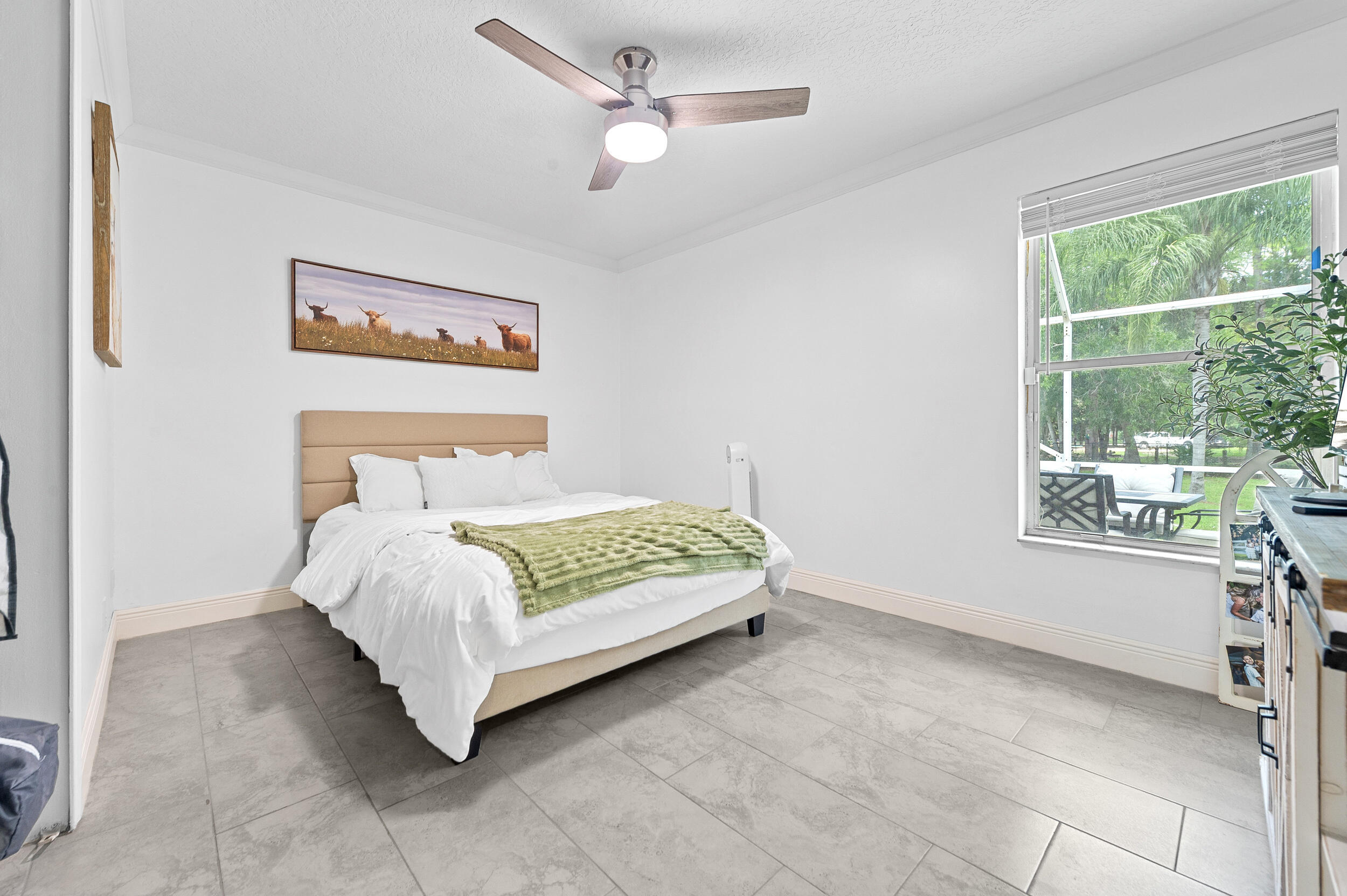 18389 41st Road North The Acreage, FL 33470 - Photo 27 of 44 a bed sitting in a room next to a window