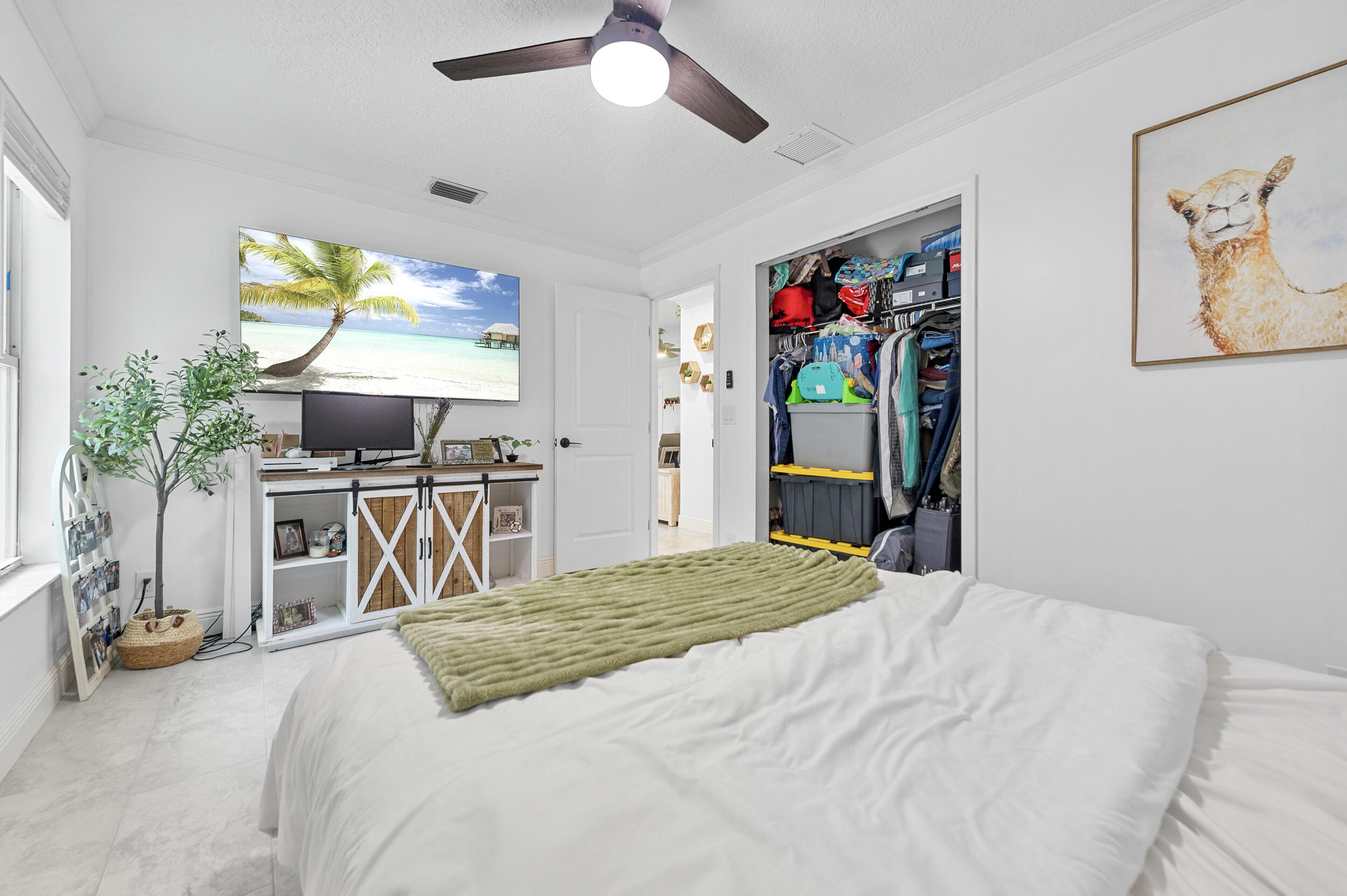 18389 41st Road North The Acreage, FL 33470 - Photo 28 of 44 a bedroom with a bed and a flat screen tv