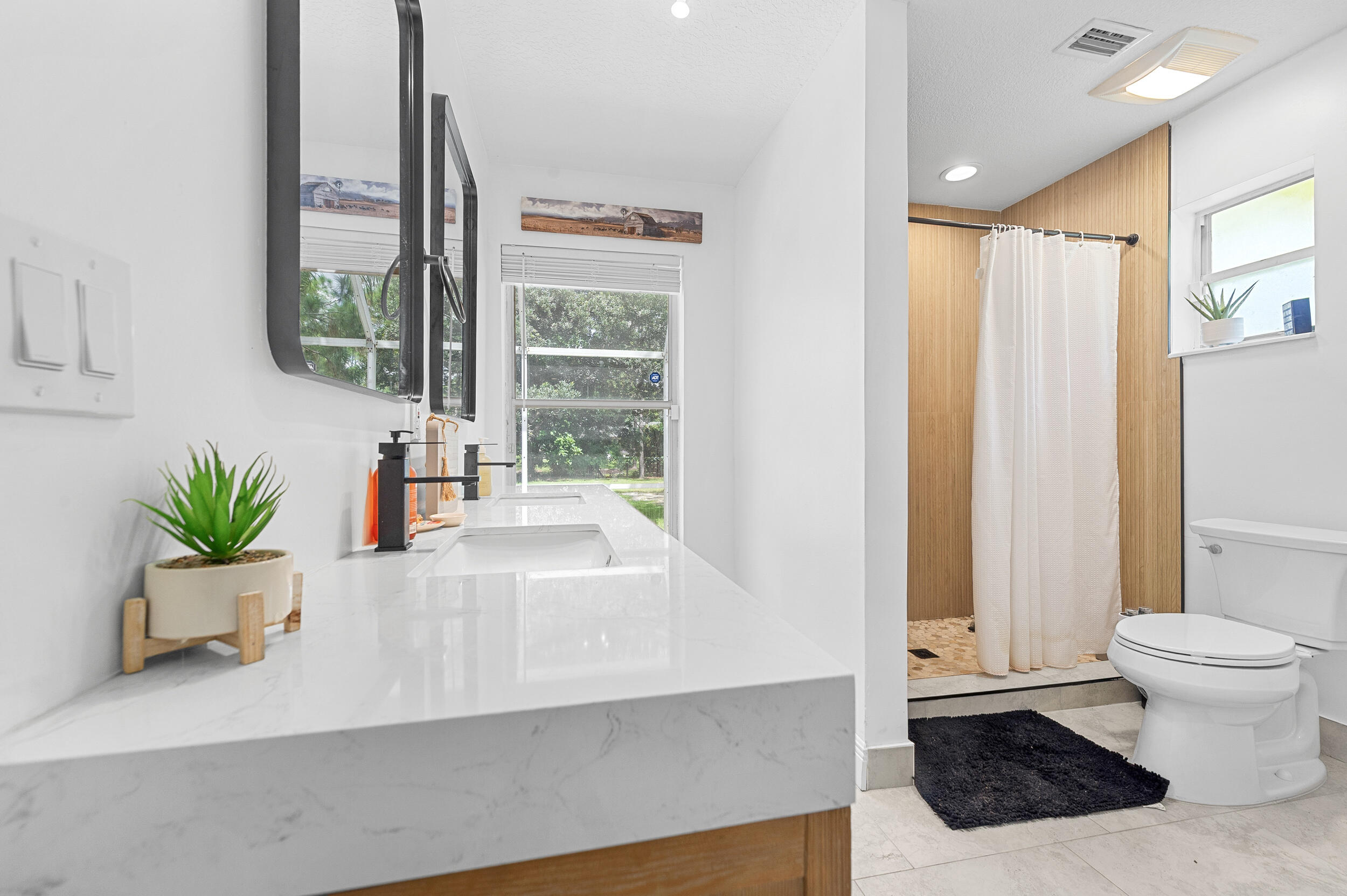 18389 41st Road North The Acreage, FL 33470 - Photo 29 of 44 a white bath tub sitting in a bathroom next to a window