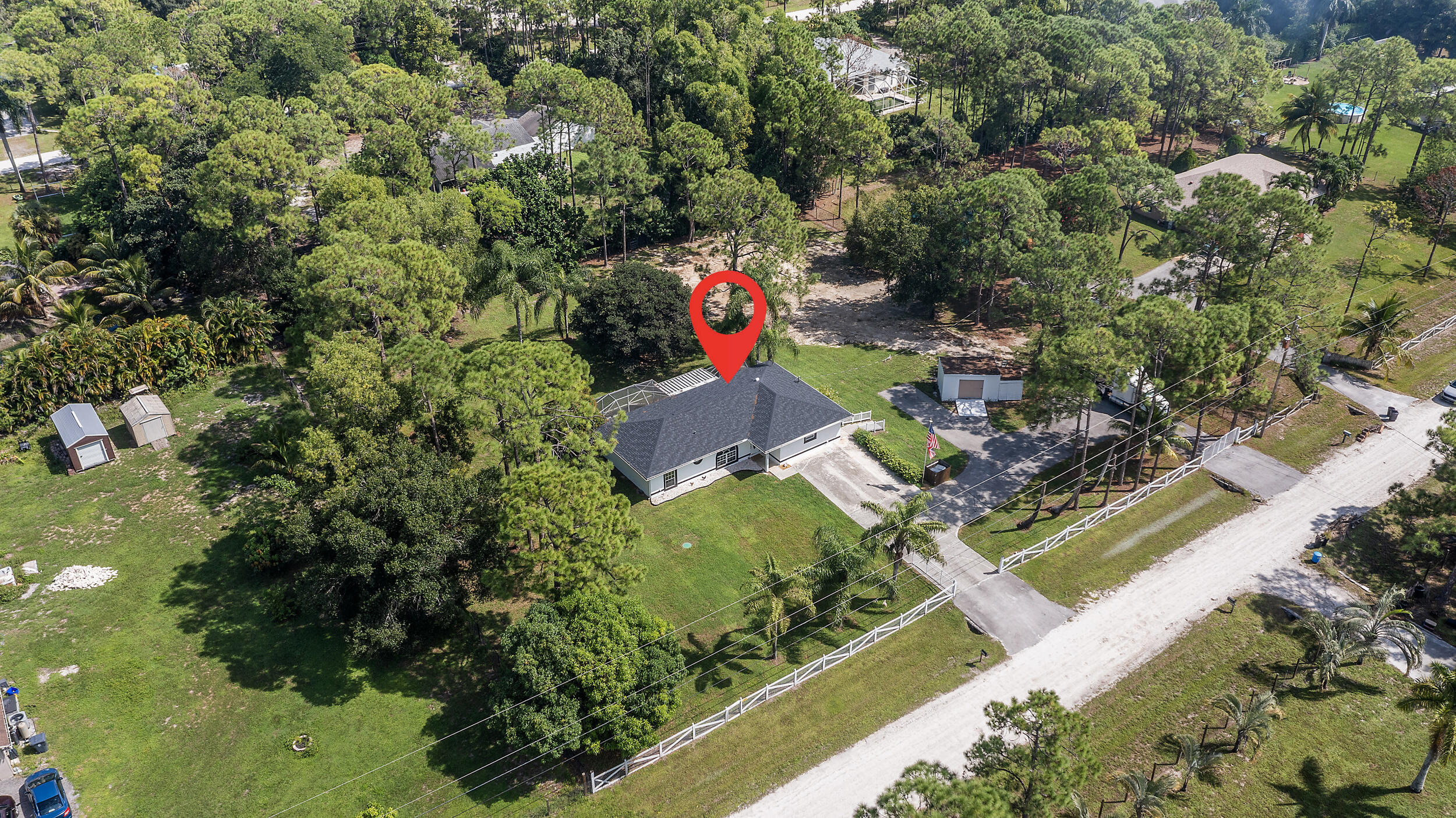 18389 41st Road North The Acreage, FL 33470 - Photo 3 of 44 an aerial view of a house with a yard and swimming pool