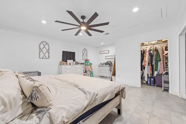 a bedroom with a large bed and a tv