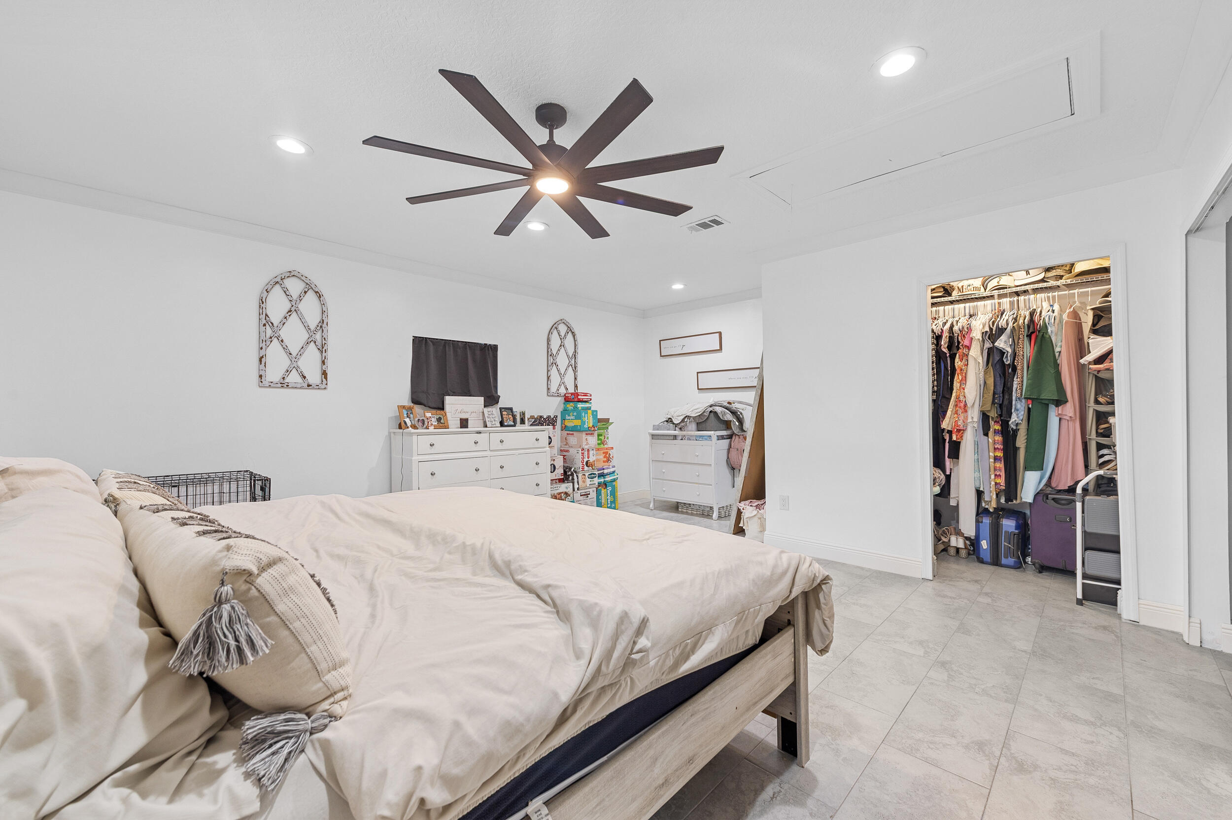 18389 41st Road North The Acreage, FL 33470 - Photo 35 of 44 a bedroom with a large bed and a tv