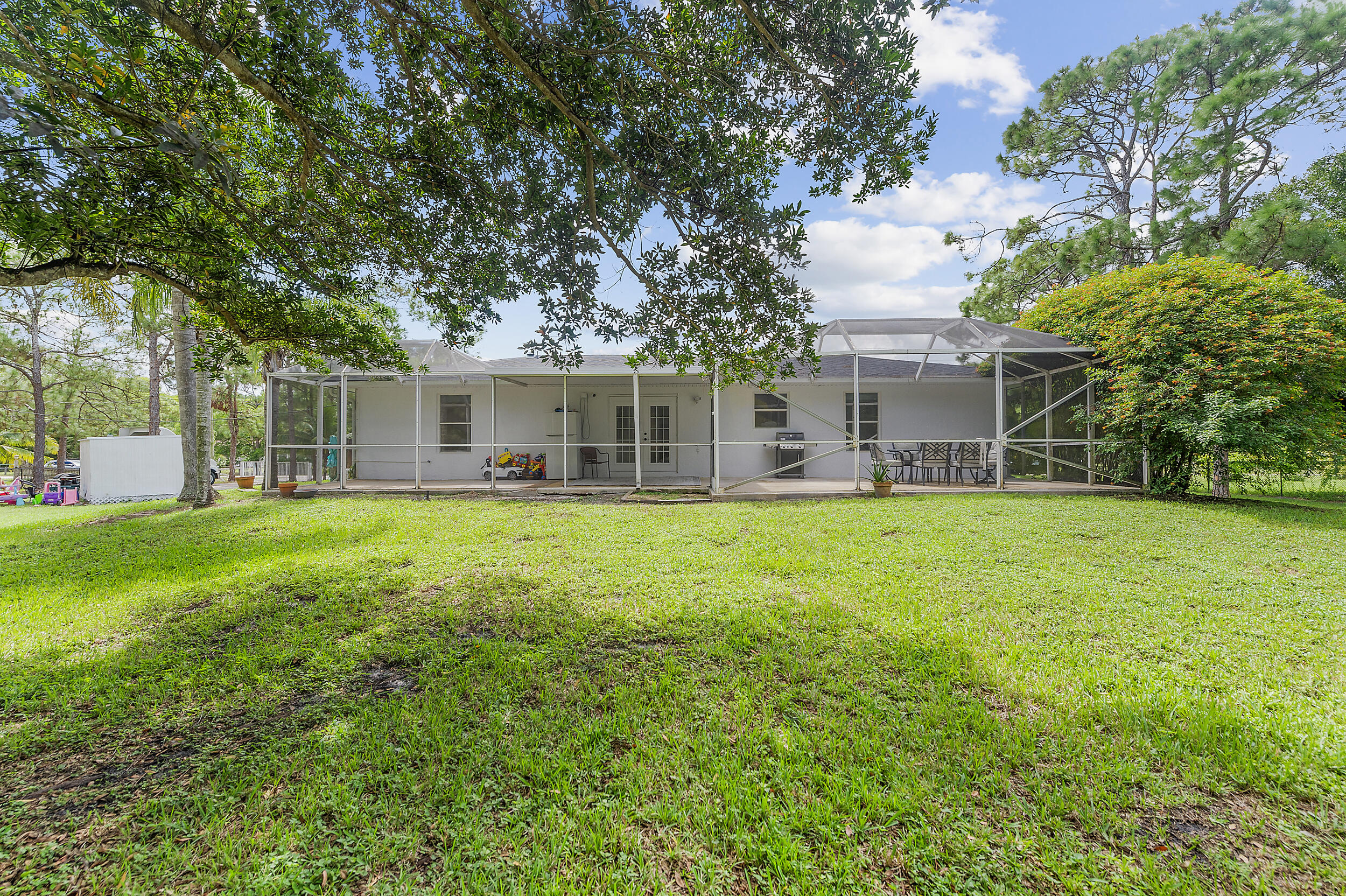 18389 41st Road North The Acreage, FL 33470 - Photo 41 of 44 a front view of house with yard and green space