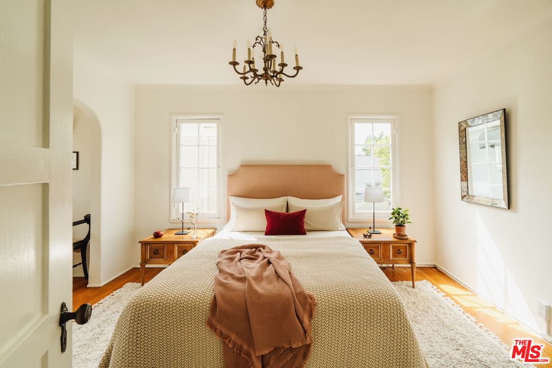3325 Lowry Road Los Angeles, CA 90027 - Photo 44 of 73 a bedroom with a bed and a chandelier