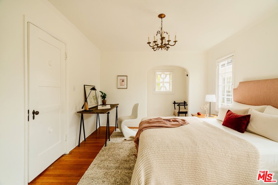 3325 Lowry Road Los Angeles, CA 90027 - Photo 45 of 73 a bed room with a bed and a chandelier