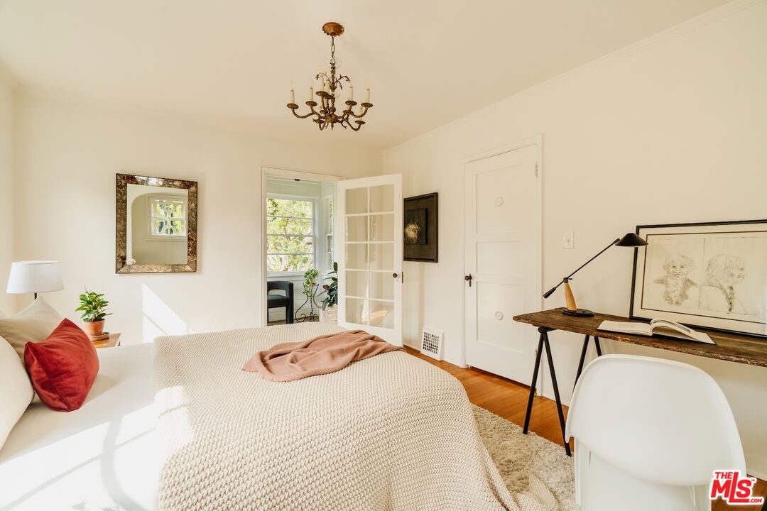 3325 Lowry Road Los Angeles, CA 90027 - Photo 47 of 73 a bedroom with a bed and a chandelier