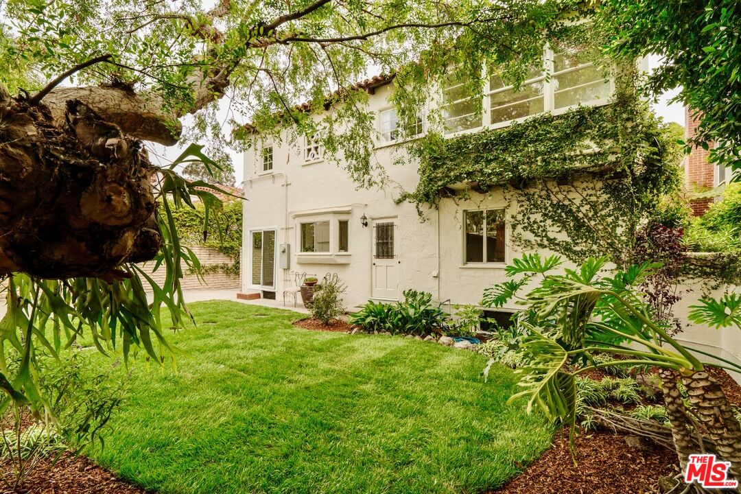 3325 Lowry Road Los Angeles, CA 90027 - Photo 63 of 73 a view of a white house next to a yard with plants and trees