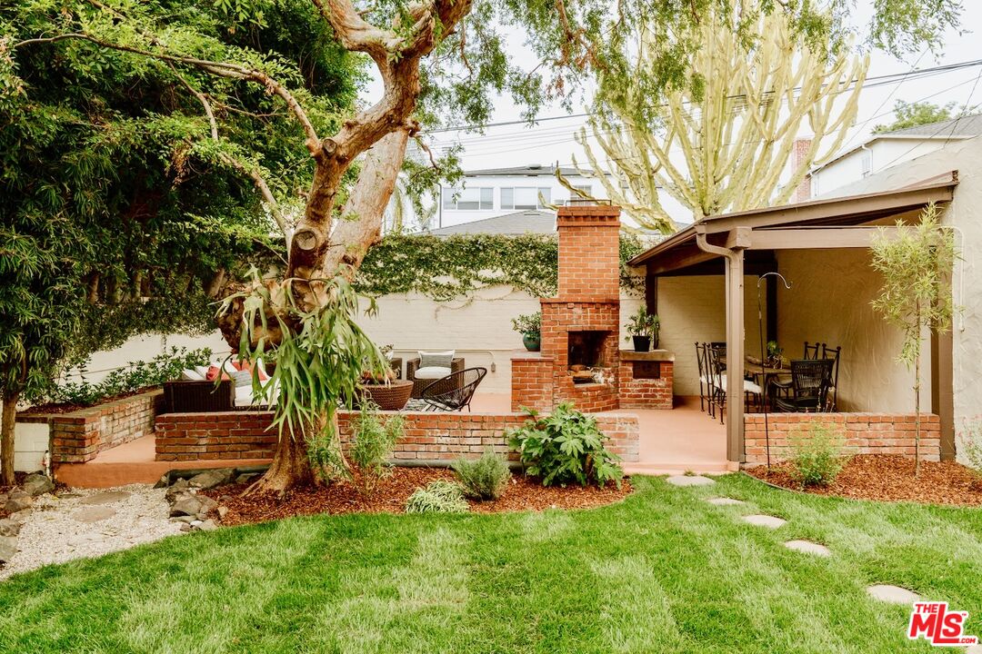 3325 Lowry Road Los Angeles, CA 90027 - Photo 64 of 73 a view of a chair and tables in the back yard of the house