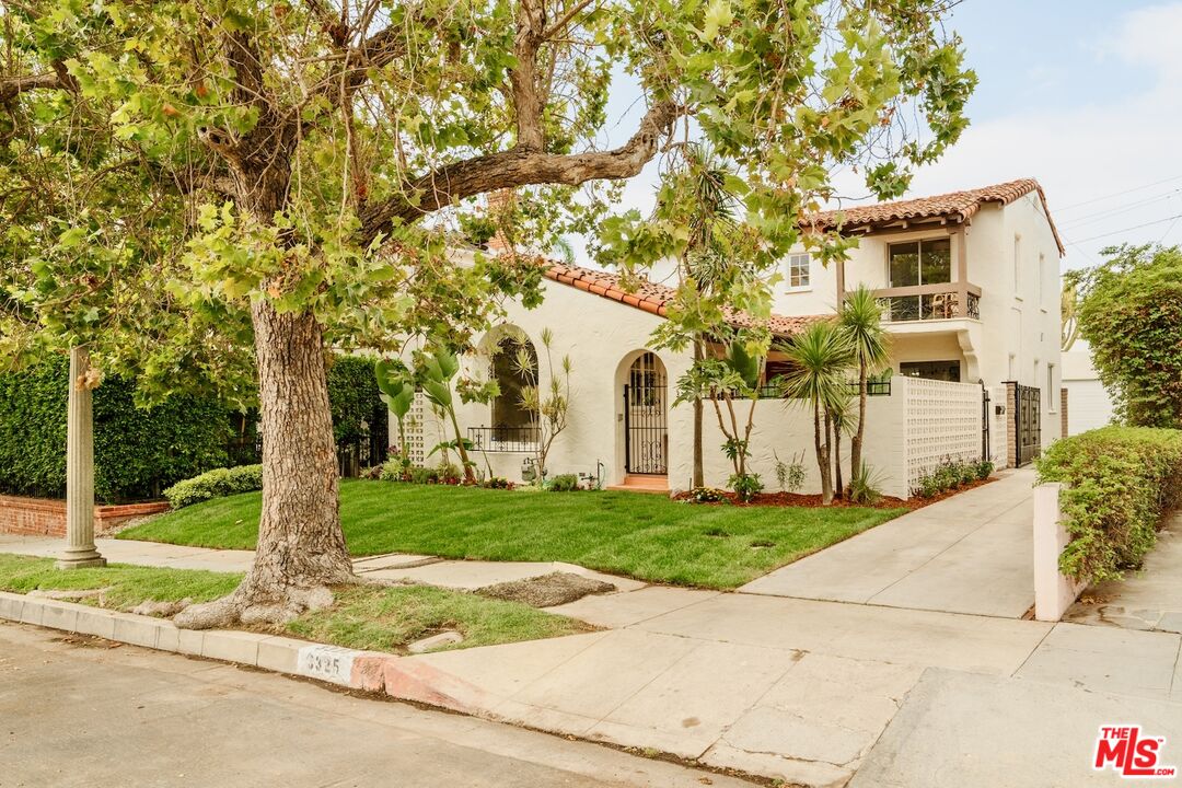 3325 Lowry Road Los Angeles, CA 90027 - Photo 72 of 73 a front view of a house with a garden and trees