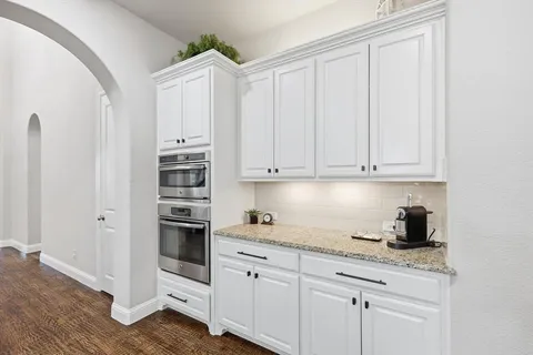 a kitchen with stainless steel appliances granite countertop a refrigerator sink and cabinets