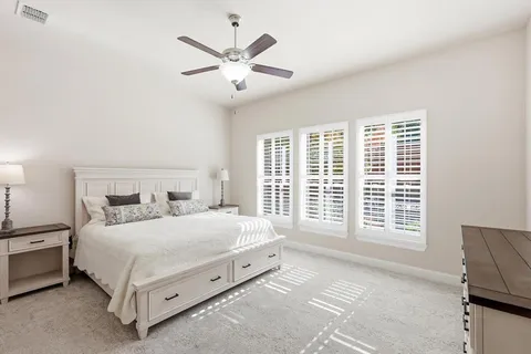 a bedroom with a large bed and a large window