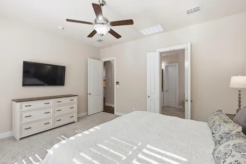 a bedroom with a bed and a flat screen tv in it