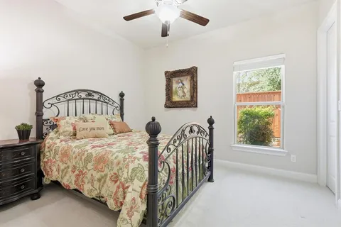 a bedroom with bed and a window