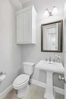 a white toilet sitting next to a bathroom sink