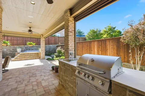 a view of a patio with table and chairs potted plants and wooden fence