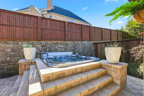 a view of a chairs and table in the back yard of the house