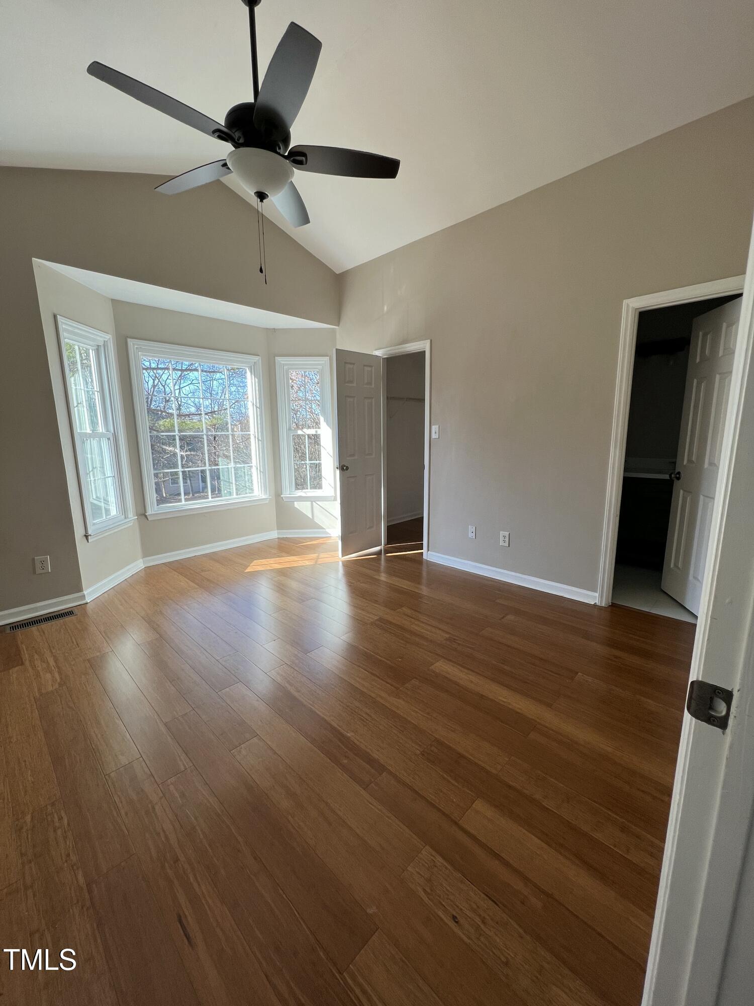 4416 Labrador Drive Raleigh, NC 27616 - Photo 11 of 19 a view of an empty room with wooden floor and a window