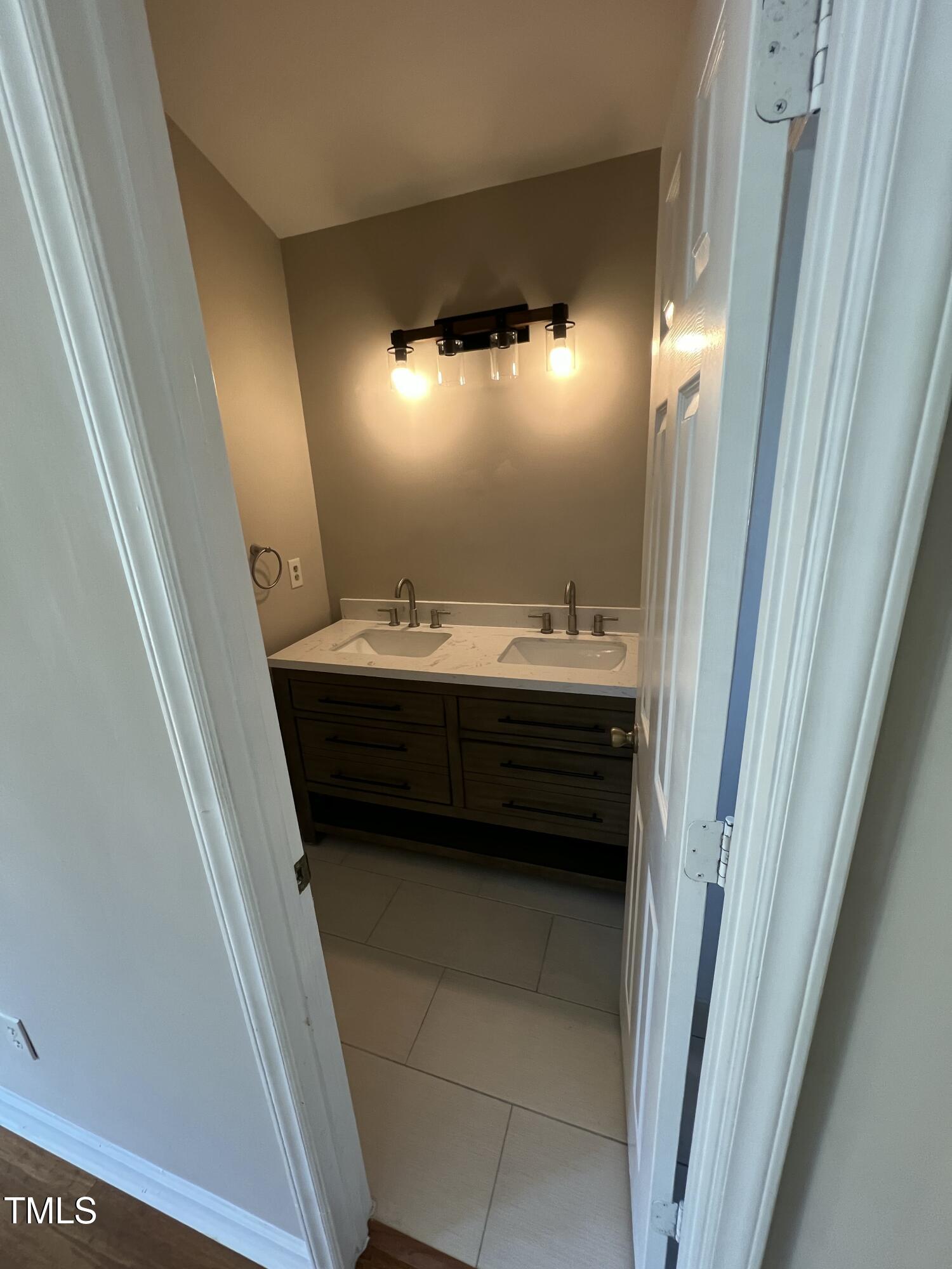 4416 Labrador Drive Raleigh, NC 27616 - Photo 14 of 19 a bathroom with a sink a toilet and mirror