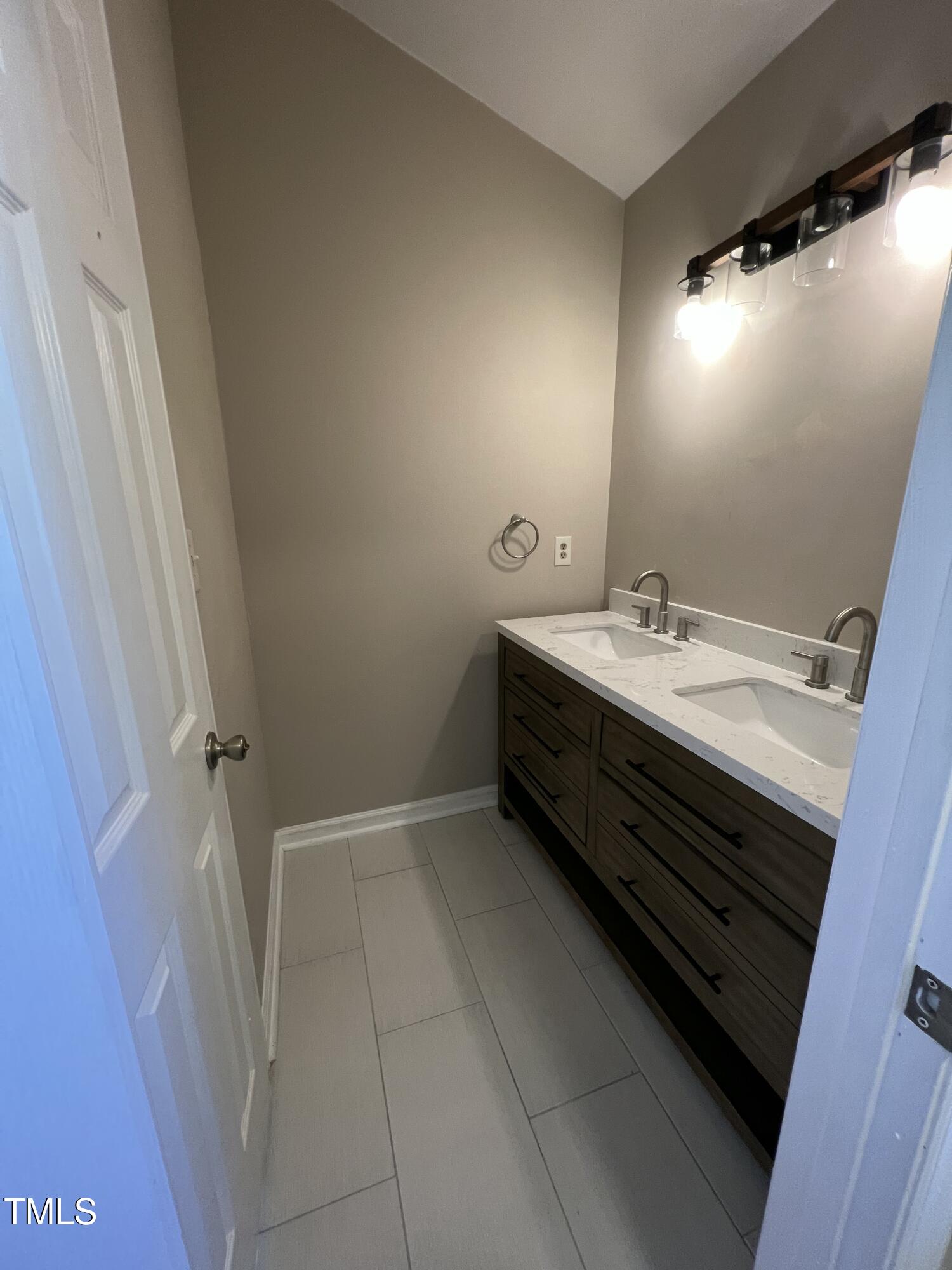 4416 Labrador Drive Raleigh, NC 27616 - Photo 15 of 19 a bathroom with a sink and a mirror