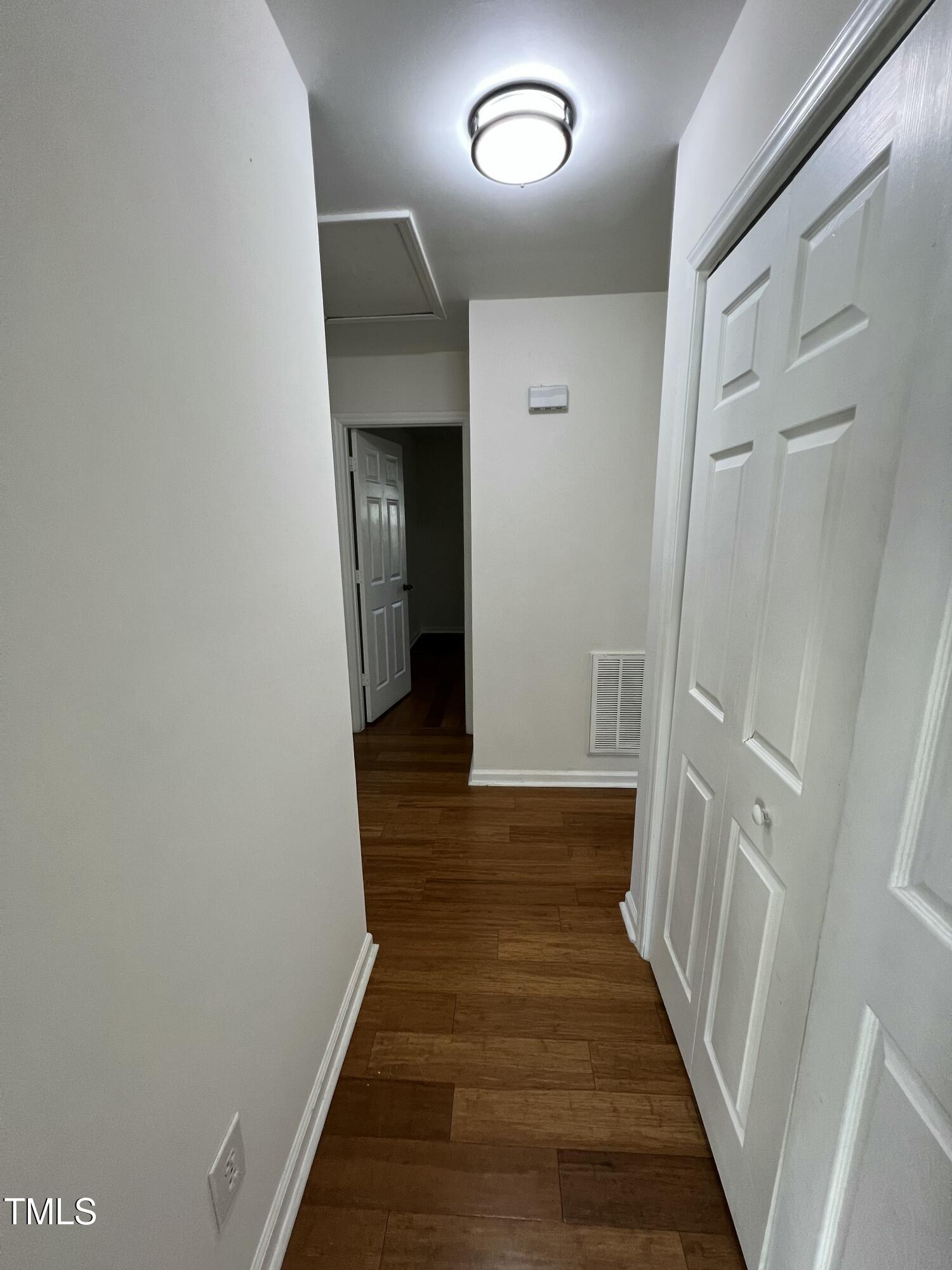 4416 Labrador Drive Raleigh, NC 27616 - Photo 17 of 19 a view of a hallway with wooden floor and staircase