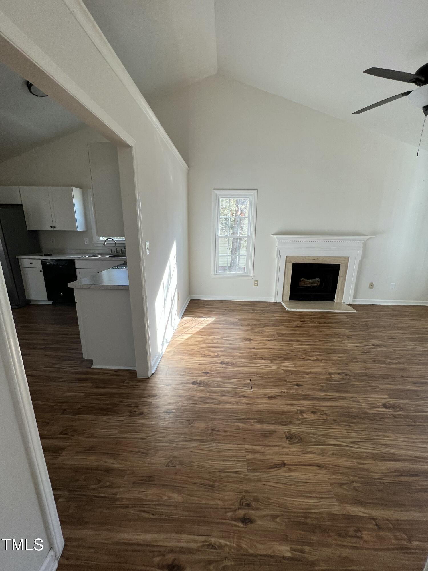 4416 Labrador Drive Raleigh, NC 27616 - Photo 5 of 19 a view of a livingroom with wooden floor and a fireplace