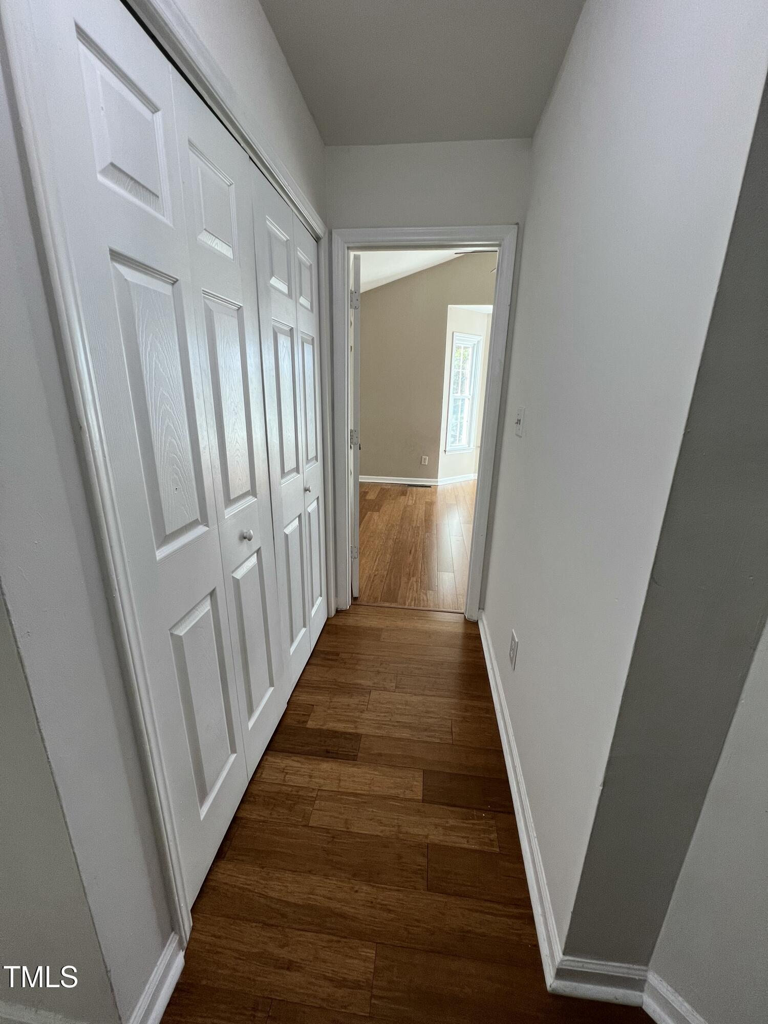 4416 Labrador Drive Raleigh, NC 27616 - Photo 10 of 19 a view of a hallway with wooden floor and staircase
