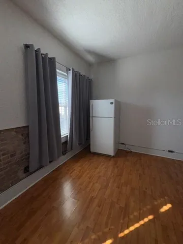 a view of an empty room with a kitchen