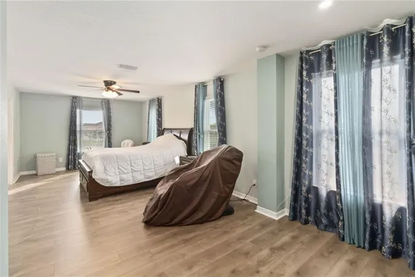 a bedroom with a bed and a chandelier