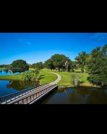 a view of a lake with a yard and trees
