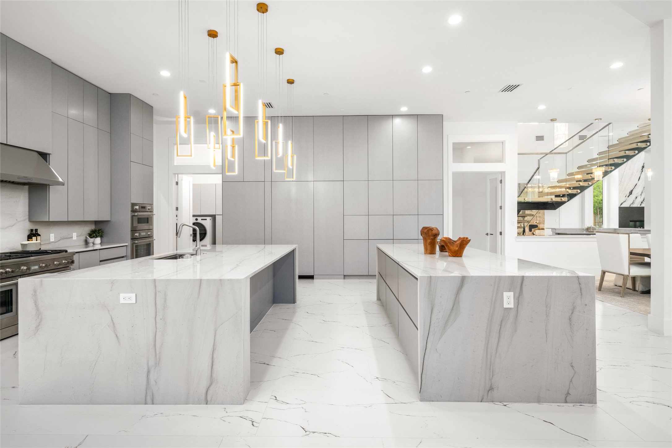 625 Piney Point Road Houston, TX 77024 - Photo 18 of 47 The kitchen is thoughtfully outfitted with a full-size, integrated Thermador refrigerator and freezer, a professional-grade 48-inch Thermador gas range with griddle, and a total of four ovens to accommodate even the most ambitious culinary endeavors. A sleek pot filler, hidden appliance pantry, and an expansive walk-in pantry—complete with abundant storage and a secondary sink.