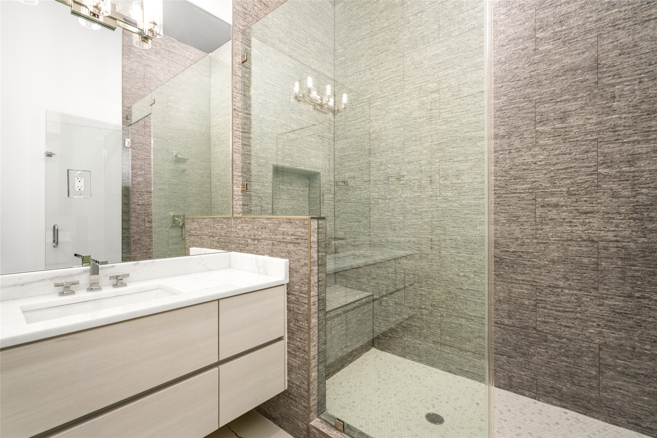 625 Piney Point Road Houston, TX 77024 - Photo 31 of 47 The ensuite bathrooms feature sleek floating vanities topped with quartzite, spacious walk-in showers with built-in benches, and elegant mirror-mounted accent lighting for a modern, spa-like ambiance.