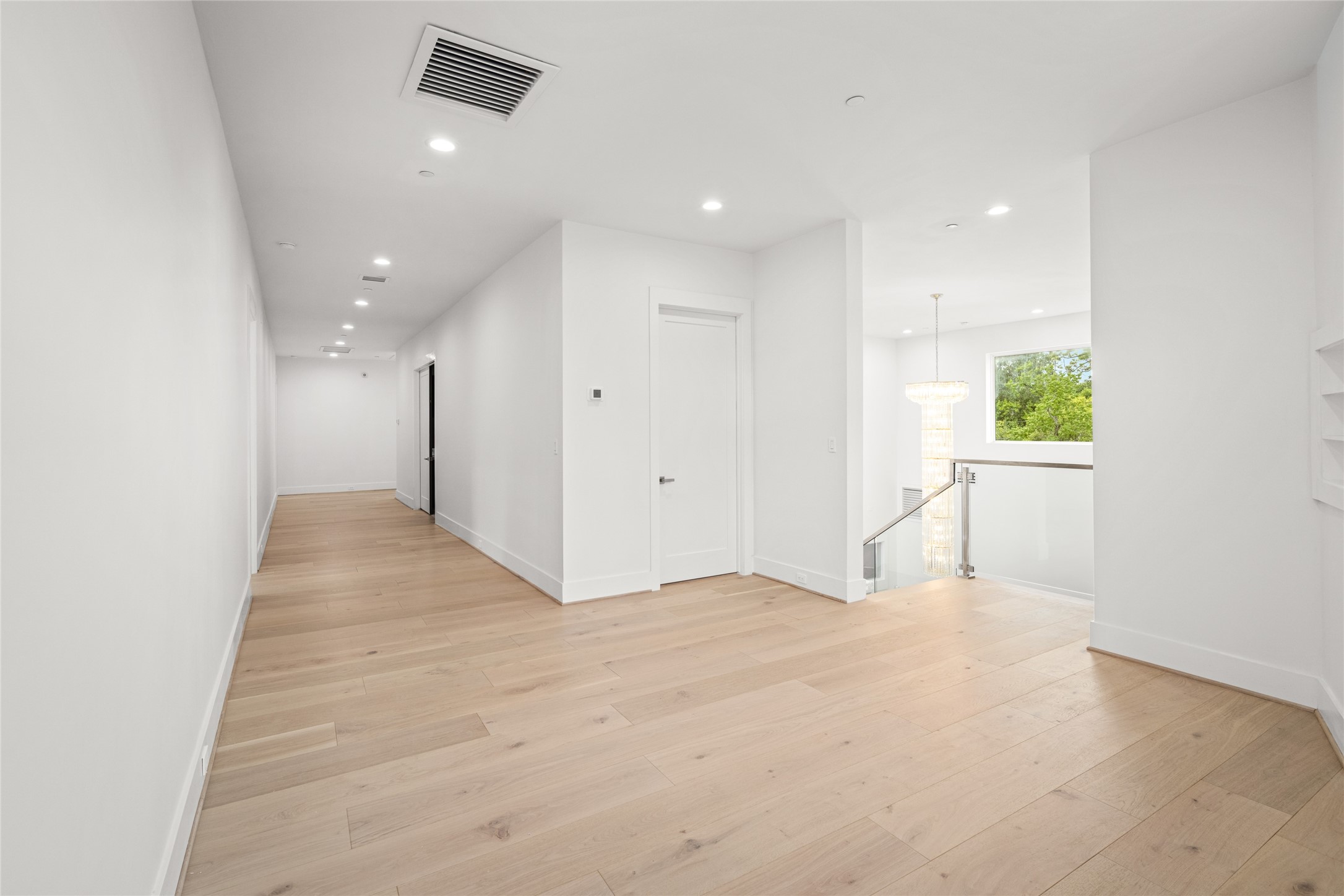 625 Piney Point Road Houston, TX 77024 - Photo 32 of 47 At the top of the stairs, a versatile flex space awaits—ideal as a secondary TV lounge, reading/study area, or whatever best suits your lifestyle. A full-size bathroom nearby features a freestanding soaking tub and a striking polished porcelain accent wall.