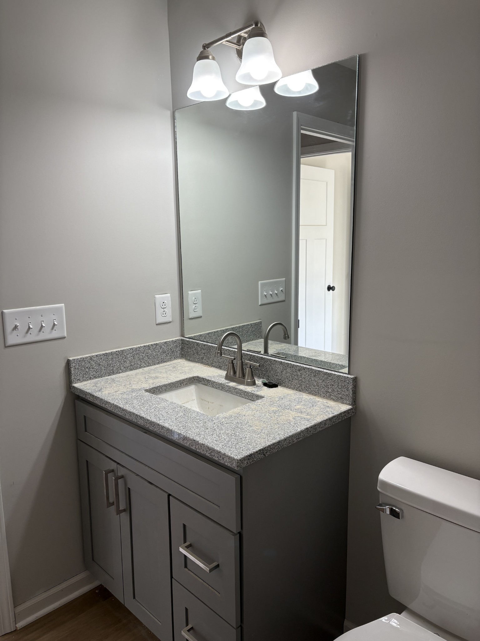 2260 Collier Road Cornersville, TN 37047 - Photo 11 of 15 a bathroom with a granite countertop sink a toilet and a mirror