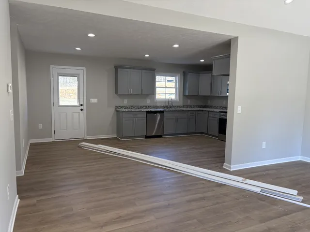 a large kitchen with a sink and a stove top oven