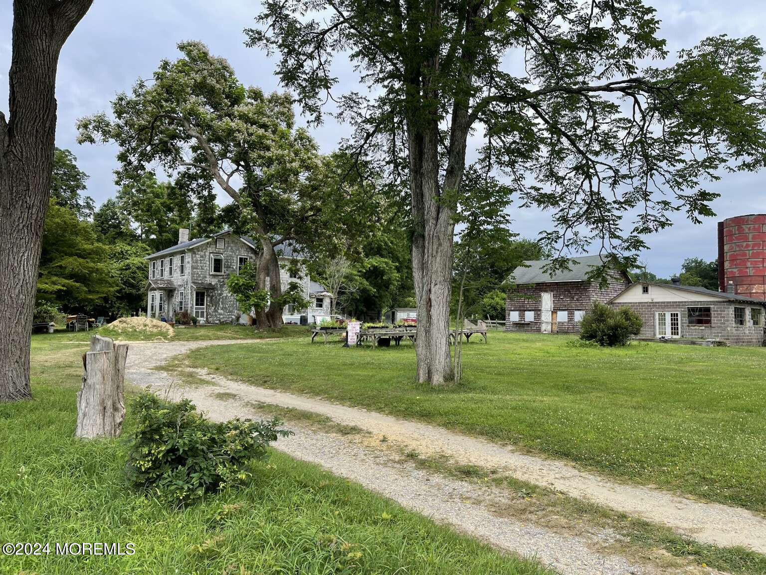 98 Merrick Road Farmingdale, NJ 07727 - Photo 1 of 1 a view of a big house with a big yard and large trees