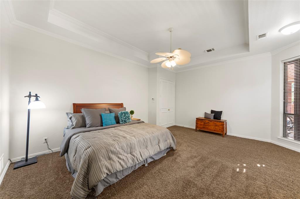 905 Sonora Drive Allen, TX 75013 - Photo 16 of 40 a bedroom with a bed and a chandelier