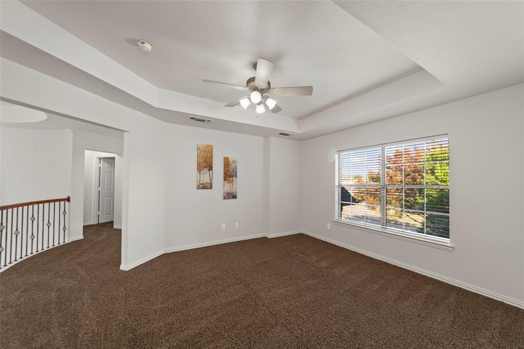 905 Sonora Drive Allen, TX 75013 - Photo 22 of 40 en empty room with windows and ceiling fan