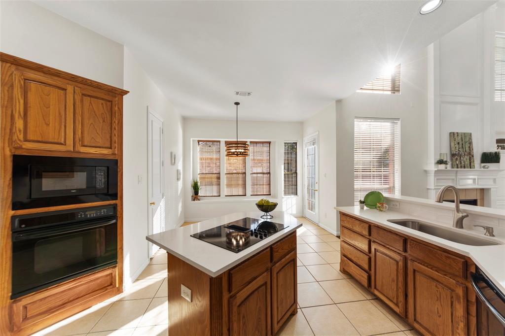 905 Sonora Drive Allen, TX 75013 - Photo 8 of 40 a kitchen with stainless steel appliances a stove a sink and a microwave