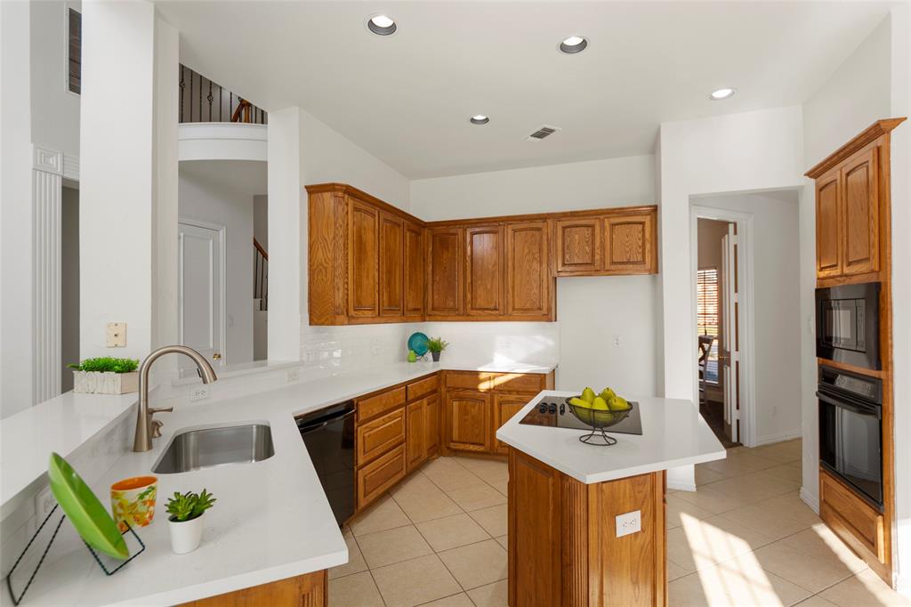 905 Sonora Drive Allen, TX 75013 - Photo 9 of 40 a kitchen with a sink a refrigerator and a stove