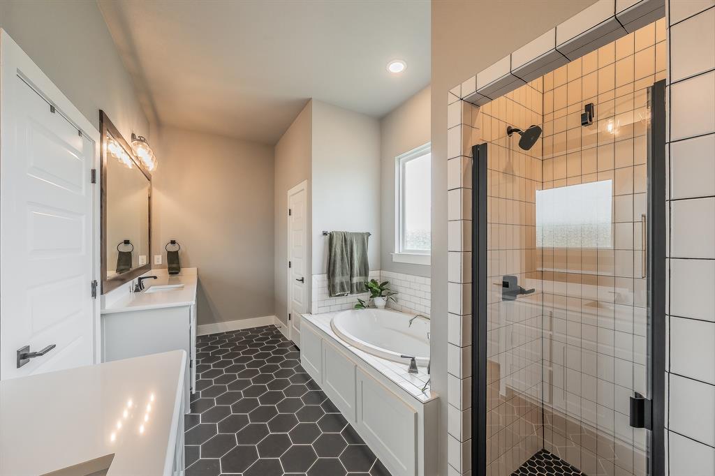 2004 Feather Lane Weatherford, TX 76088 - Photo 15 of 40 a bathroom with a glass door shower a sink and a mirror