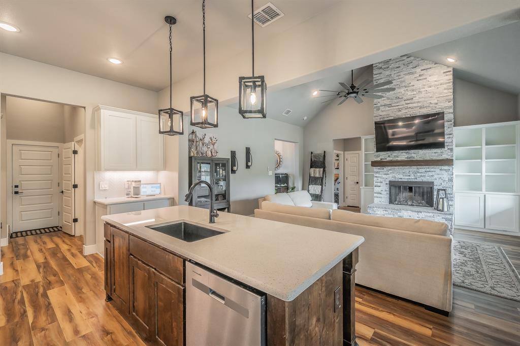 2004 Feather Lane Weatherford, TX 76088 - Photo 9 of 40 a kitchen with a sink a counter top space stainless steel appliances and a chandelier