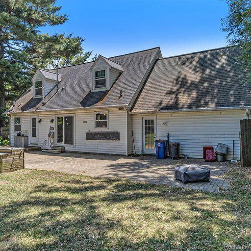 4190 Highland Road Highland, MI 48357 - Photo 21 of 27 Rear view, HUGE paver stone patio