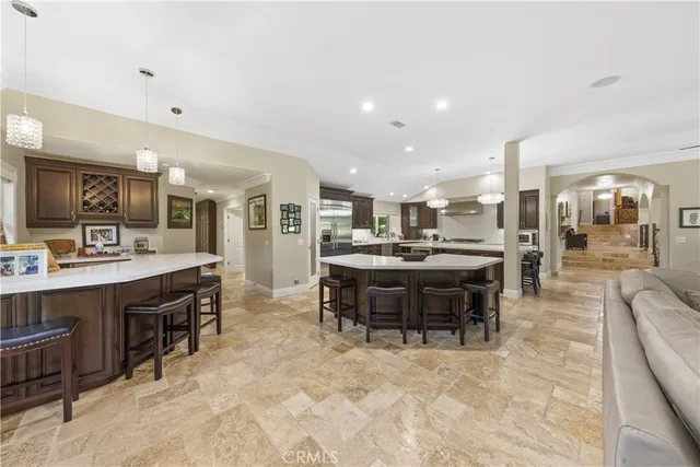 a dining room with furniture a chandelier and wooden floor