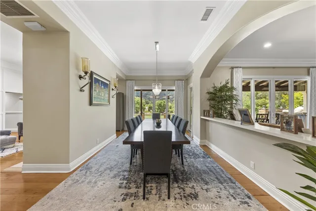 a living room with furniture kitchen view and a chandelier