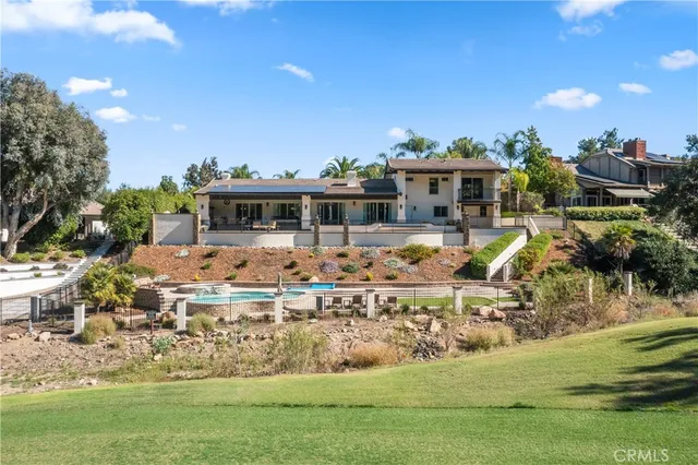 a front view of a house with potted plants