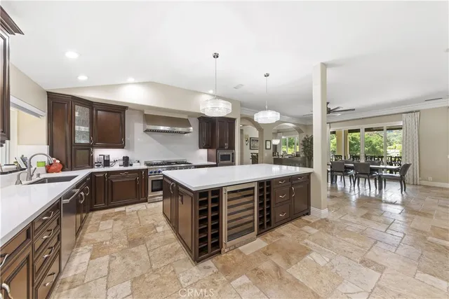 a large kitchen with a large counter space and wooden floor