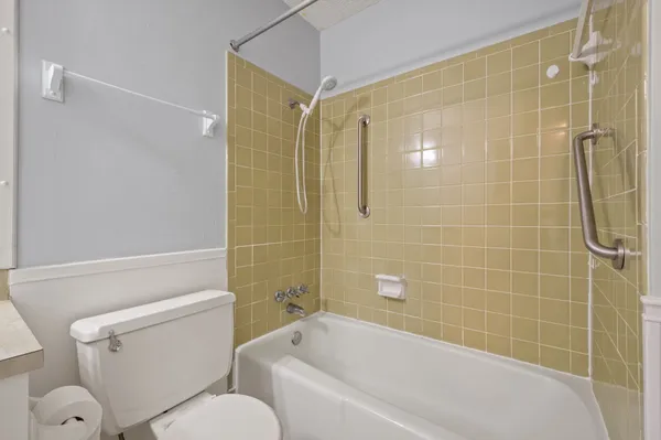 a bathroom with a toilet and shower