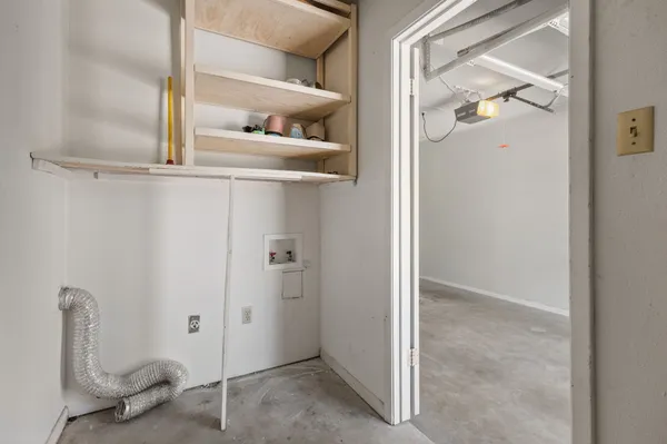 a view of a hallway with a dining area window and wooden floor