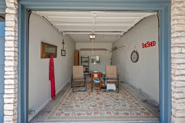 a view of a hallway with a dining area window and wooden floor